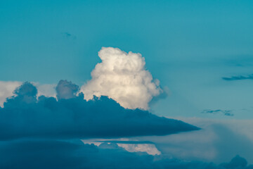 Cumulonimbus is a dense, towering vertical cloud, Towering cumulonimbus clouds are typically...