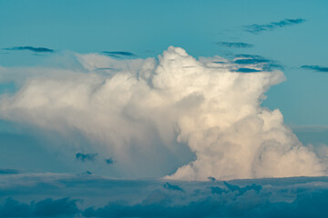 Cumulonimbus is a dense, towering vertical cloud, Towering cumulonimbus clouds are typically...