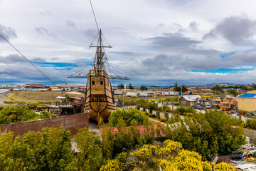 Punta Arenas city in Chile, Patagonia. Ships in port maritime old, ancient and modern ship in...