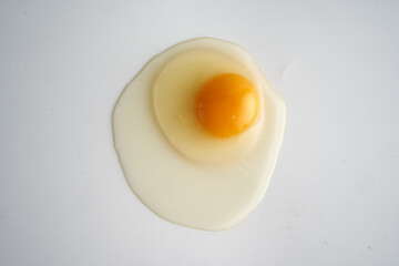 Chicken egg broken on white
