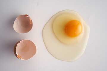 Chicken egg broken on white