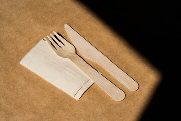 Wooden cutlery on table with paper napkin