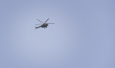 Military border helicopter against the blue evening sky, minimalism