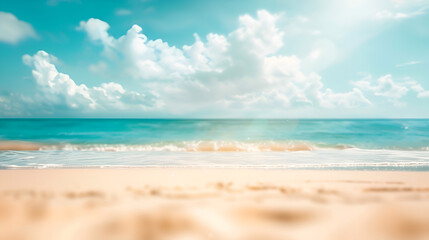 Abstract blur defocused background featuring sun rays on a tropical summer beach. Beach with golden sand, ocean, and a blue sky with white clouds in it