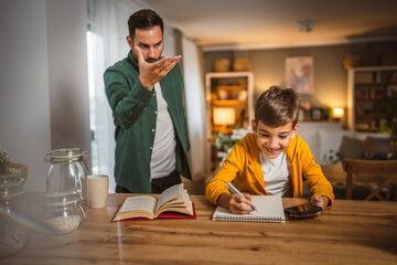 Angry father yell at his son to do homework as soon as possible