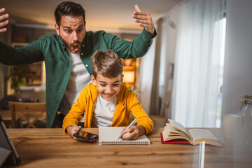 Angry father yell at his son to do homework as soon as possible