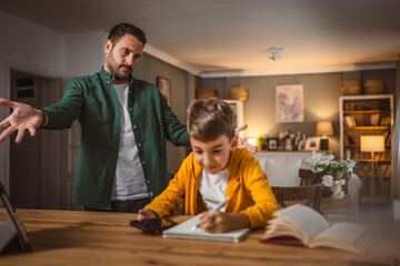 Angry father yell at his son to do homework as soon as possible