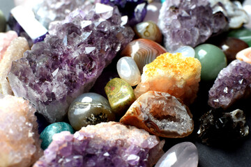 Background made of beautiful natural colored semi-precious stones. Close-up of amethyst, rose...