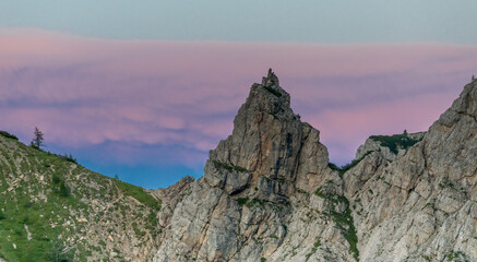 Dolomiti Alps beautiful mountain landscape. Rocky tower alpine summits in the Dolomites. Summer mountain scenic view on the hiking trekking path in the green mountain valley and blue sky with clouds