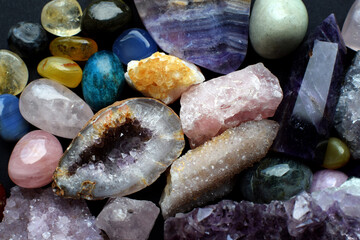 Background made of beautiful natural colored semi-precious stones. Amethyst, rose quartz and...