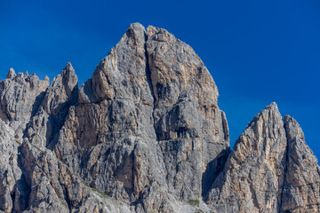 Dolomiti Alps beautiful mountain landscape. Rocky tower alpine summits in the Dolomites. Summer mountain scenic view on the hiking trekking path in the green mountain valley and blue sky with clouds