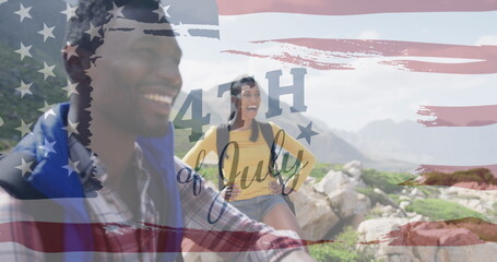 Image of independence day text over smiling diverse couple hiking