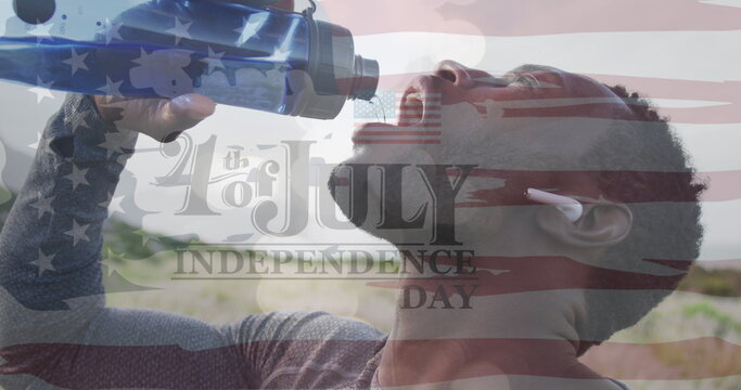 Image of independence day text over african american man drinking water and hiking - Powered by Adobe