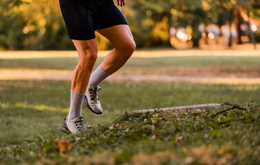 Sport running man in cross country forest trail run.