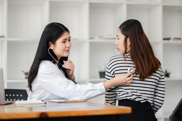 Female Doctor Examining Patient with Stethoscope in Modern Medical Office, Healthcare Professional Conducting Routine Checkup, Medical Consultation, Patient Care, Health Assessment, Doctor-Patient