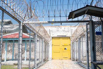 yellow wooden door used to imprison prisoners in the past