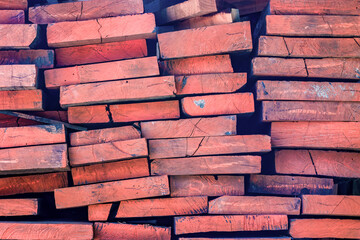 A stack of wood planks marked in red, ready to be worked on, in a carpentry workshop in the eastern...