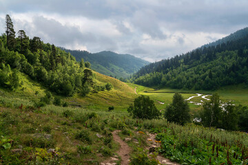 The valley of the Malaya Dukka River surrounded by the mountains of the North Caucasus and the tourist trail to the Dukka Lakes on a sunny summer day, Arkhyz, Karachay-Cherkessia, Russia © Ula Ulachka