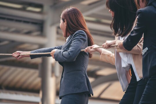 Tug of war Businesswoman Team holding hands together partnership leader teamwork. Group of business people Hands pulling rope symbol team unified teamwork Partnership Concept. diversity competition