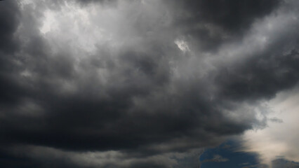 Obraz premium Dramatic dark storm thundercloud rain clouds on black sky background. Dark thunderstorm clouds rainny landscape. Meteorology danger windstorm disaster climate. Dark cloudscape storm disaster gray sky