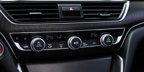  black car interior: climat control view with air conditioning button inside a car