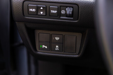 close-up of off road, parking brake, auto hold buttons. modern car interior