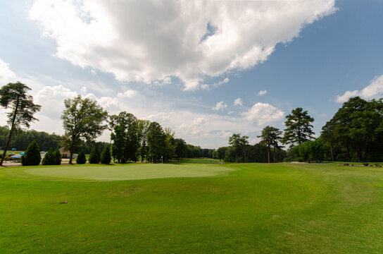 Wide Sunny Golf Course with Blue Skies and Mowed Turf