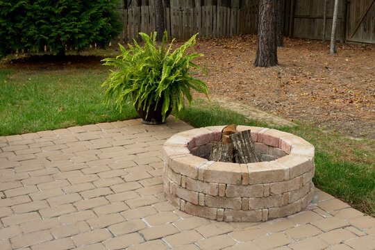 Cozy Backyard Patio with Fire Pit and Greenery