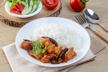 Shrimp with sauce over rice on the wooden table