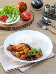 Shrimp with sauce over rice on the wooden table