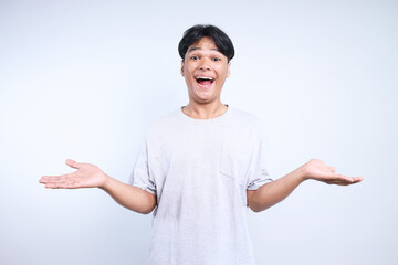 Potrait Of Excited Young Asian Man Presenting For Free Space With Hands Isolated On White Background