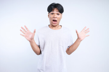 Potrait Of Funny Young Asian Man Showing Suprised Gesture Isolated On White Background