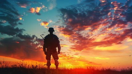 Fototapeta premium Soldier silhouette against dramatic sky - A silhouette of a soldier standing against a visually striking sunset sky symbolizes themes of patriotism and contemplation