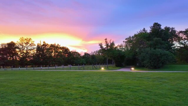 In park of Robert Tatin Museum, Coss&eacute;-le-Vivien in Mayenne department, France. Landscape at sunset and sky for copy space. First-person walking view