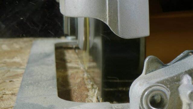 Circular Saw Cutting Piece of Wood, Dolly Out, Extreme Close Up, 4K