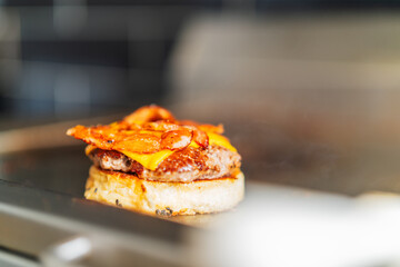 Chef assembling a hamburger in the restaurant