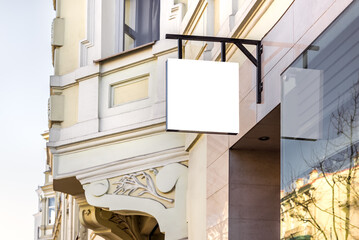 Mockup Of Restaurant White Signboard Hanging On The Wall. Store Or Boutique Square Shape Street Sign