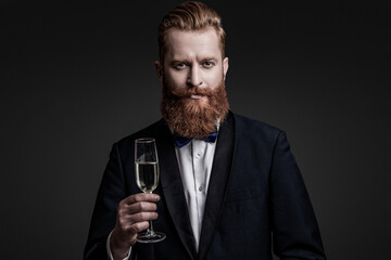 Elegant tuxedo man hold glass of champagne isolated on black. Celebrating success. Cheers. Bearded man with formal look. Celebrate with champagne. Cheering and celebrating. Sophisticated attire