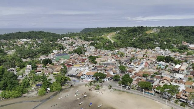Drone flies backwards from shore of Coroa Beach in Itacar&eacute; out to sea