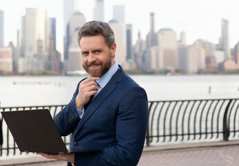 Businessman busy working on laptop or computer outdoor. Man send business email and surf on a web...