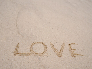 Love Symbol On a Sand Of Beach With Soft Blue Wave On Background