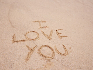 Love Symbol On a Sand Of Beach With Soft Blue Wave On Background