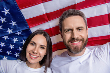 American couple embrace spirit of Independence Day with flag. Independence Day holiday. couple with...
