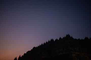 Enchanting Twilight Silhouette of Ancient Temple Against a Deepening Evening Sky: A Mystical and Serene Scene ; borobudur indonesia tourism