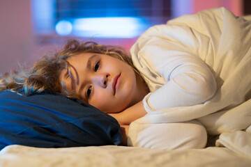 Good night. Cute drowsy sleepy child in bed, bedtime, childhood and growth kids concept, close-up...