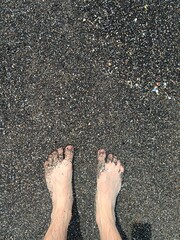 Beach travel - man walking on sand beach leaving footprints in the sand