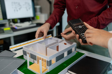 two architects are discussing about new project of the biggest housing estate company who hire...