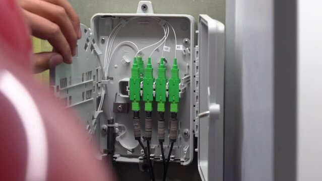 The specialist opens the fiber optic coupling