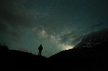Fototapeta premium Stargazing Human in Universe, a boy under milky way, Himalayas, Stars, mountain, snow, Lahaul, Himachal Pradesh, India, 