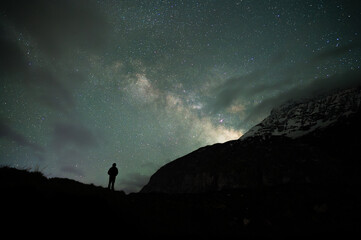 Fototapeta premium Stargazing Human in Universe, a boy under milky way, Himalayas, Stars, mountain, snow, Lahaul, Himachal Pradesh, India, 